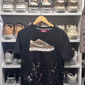 T-shirt. Signature pixelated silicone appliqué at chest hand-painted finish.